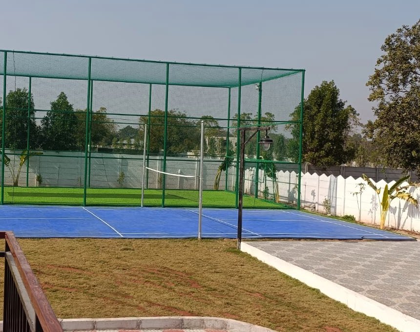 The blue multi-sport court with its net up, used for badminton and pickleball.