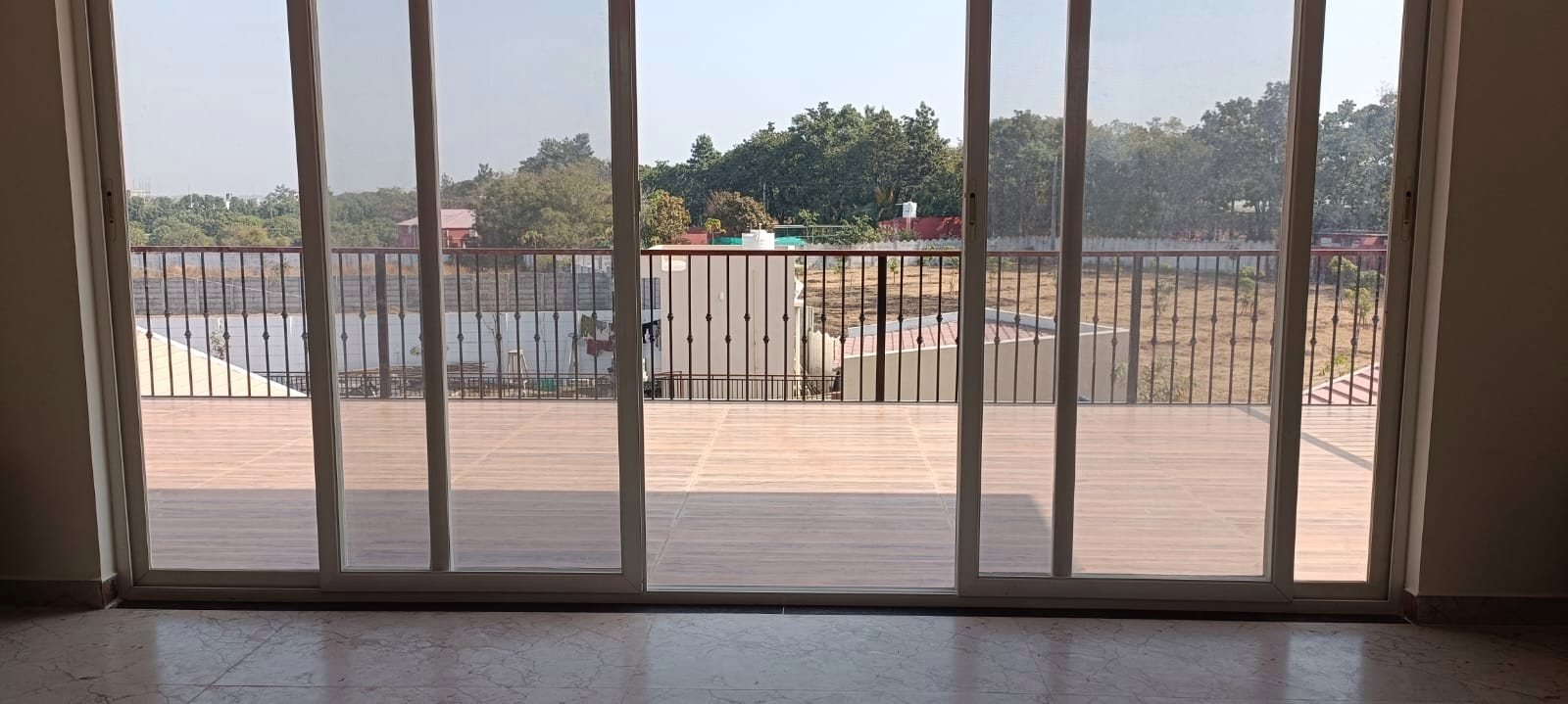 Full-height sliding doors opening from the indoor space onto the terrace.