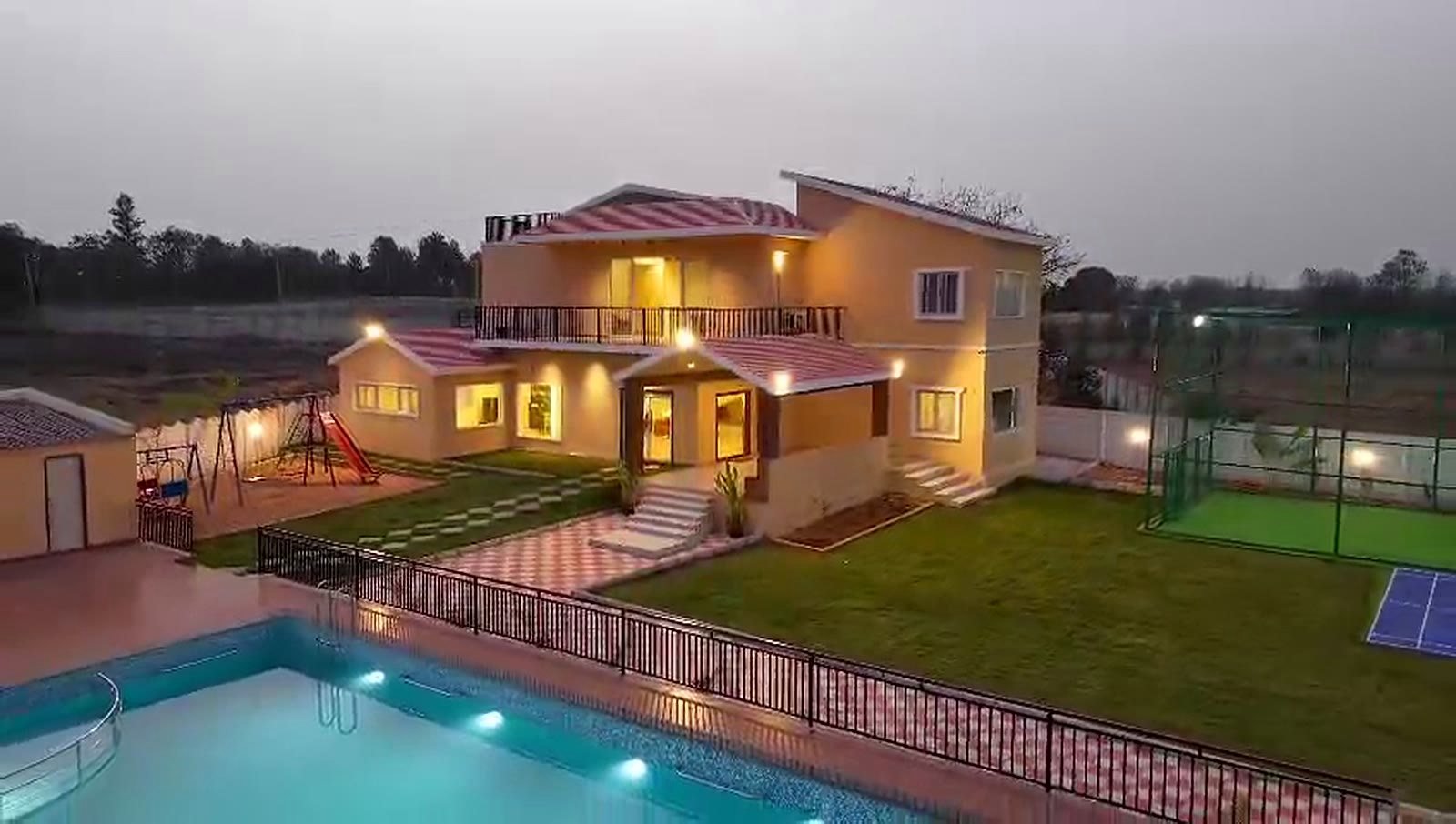 The farmhouse and pool at dusk — the opening frame of the property tour.